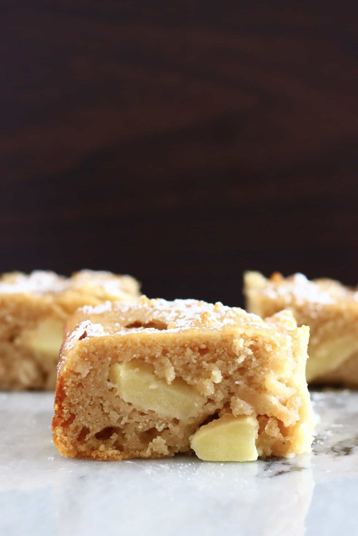 Three square pieces of gluten-free vegan apple snack cake