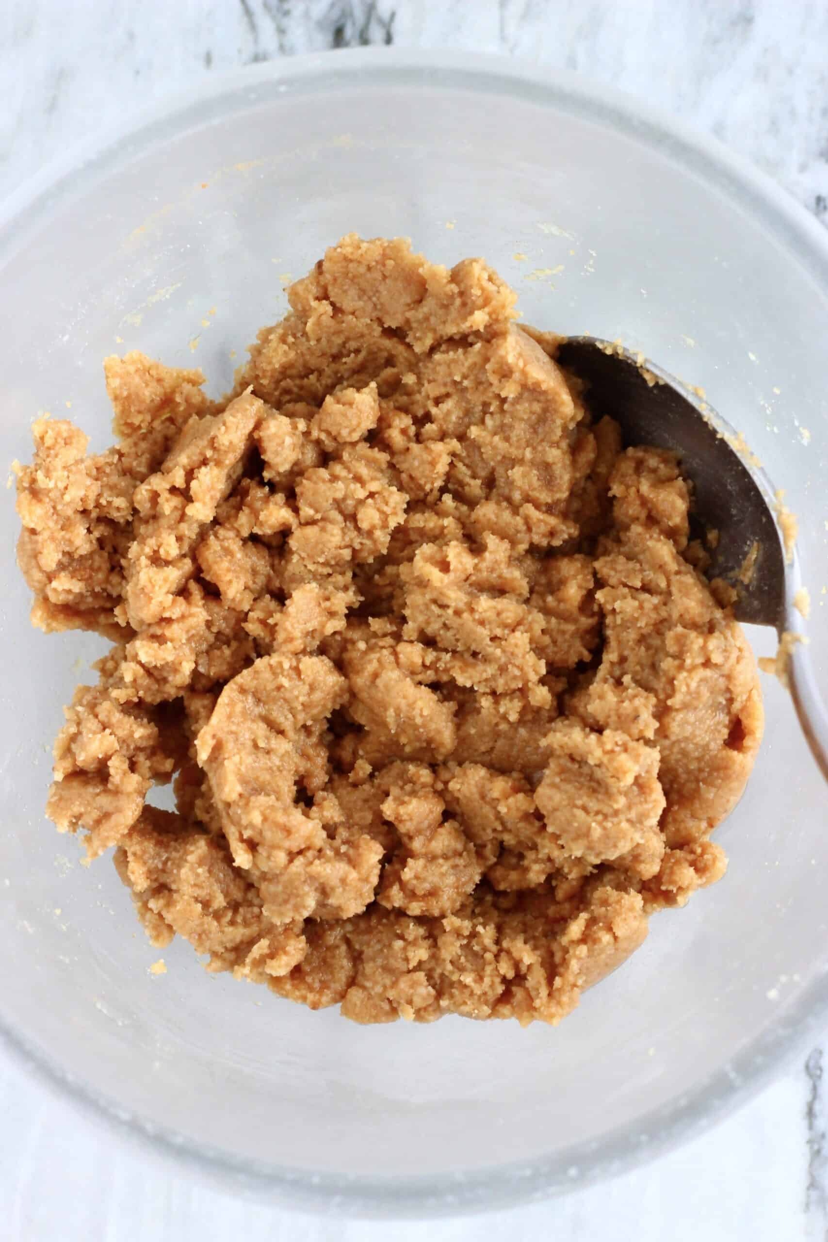 Vegan apple crumb cake crumble topping in a bowl with a spoon