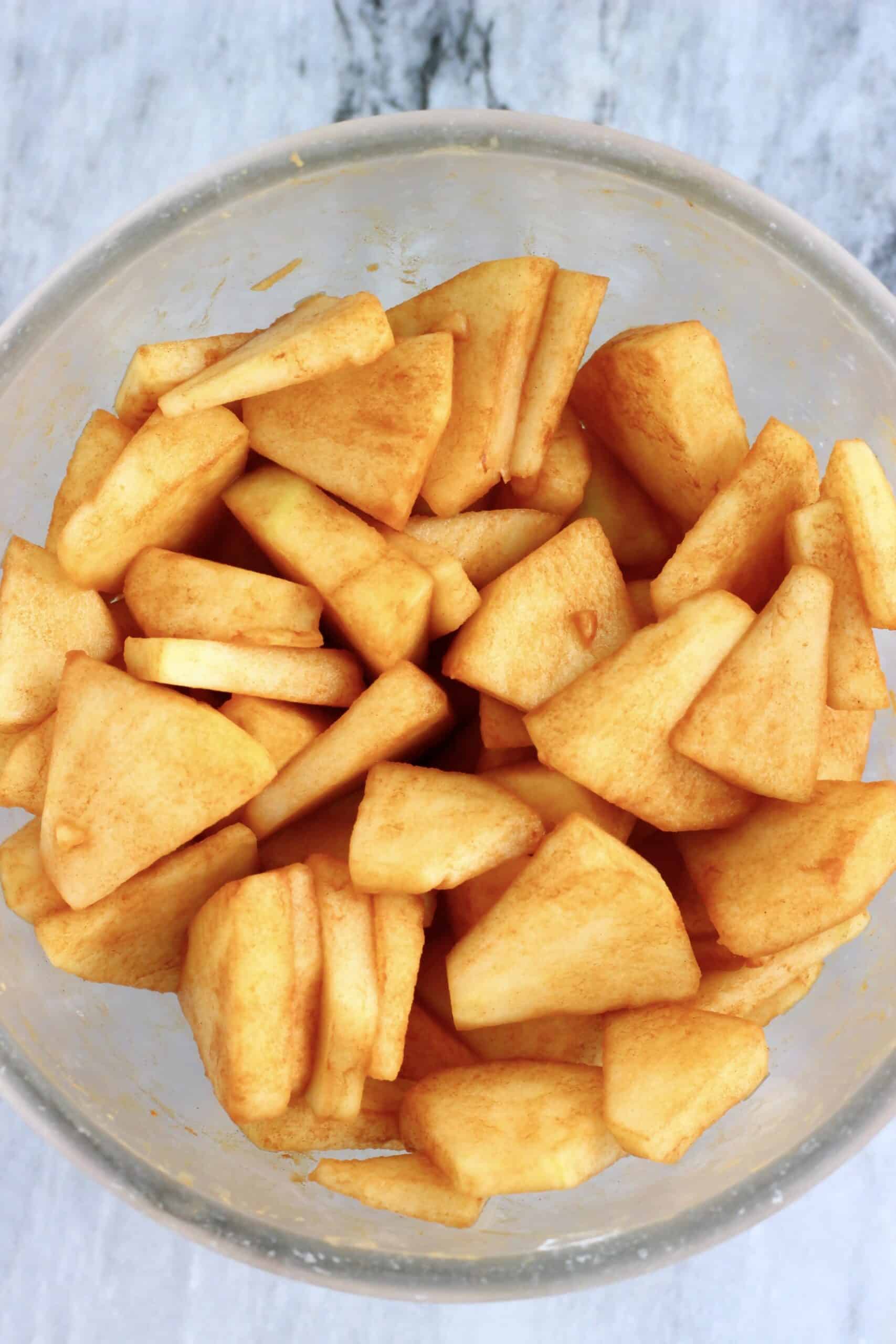 Diced apple pieces with cinnamon in a bowl