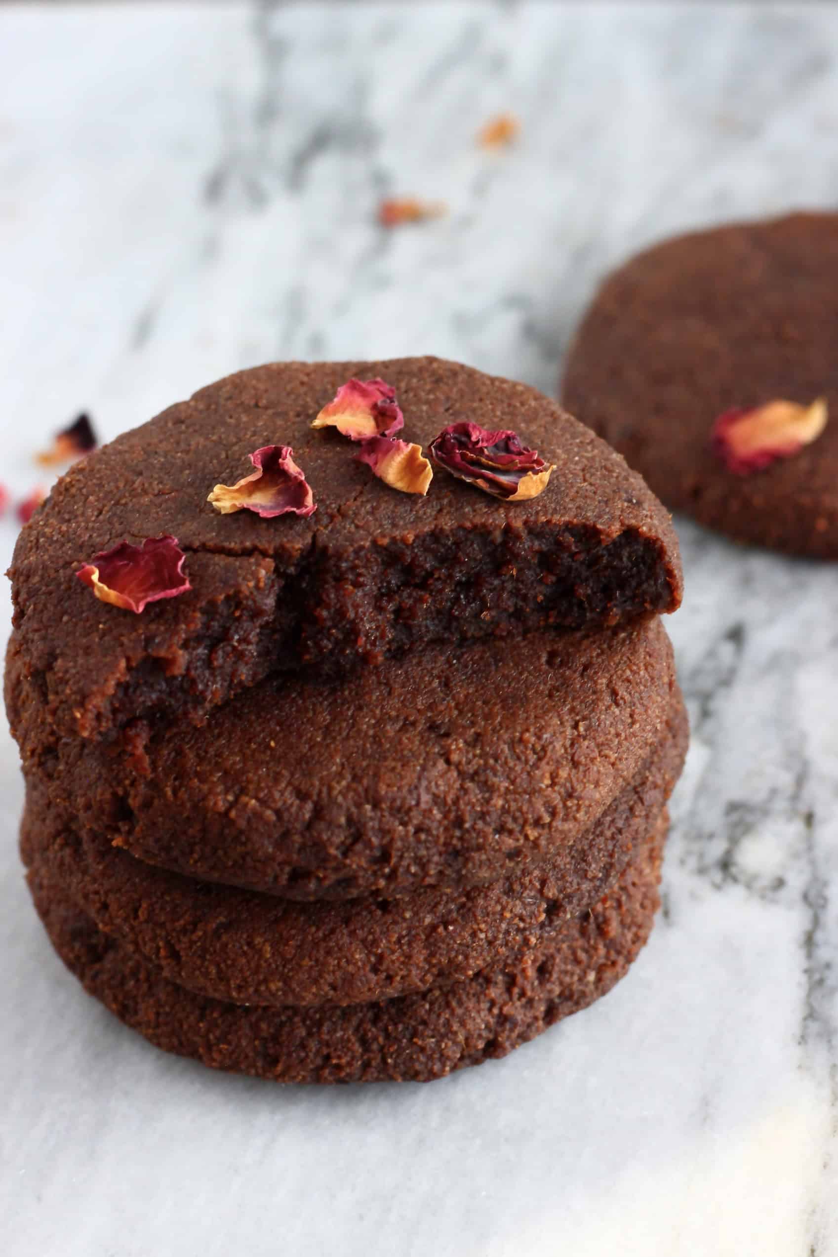 A stack of gluten-free vegan chocolate brownie cookies on a marble background