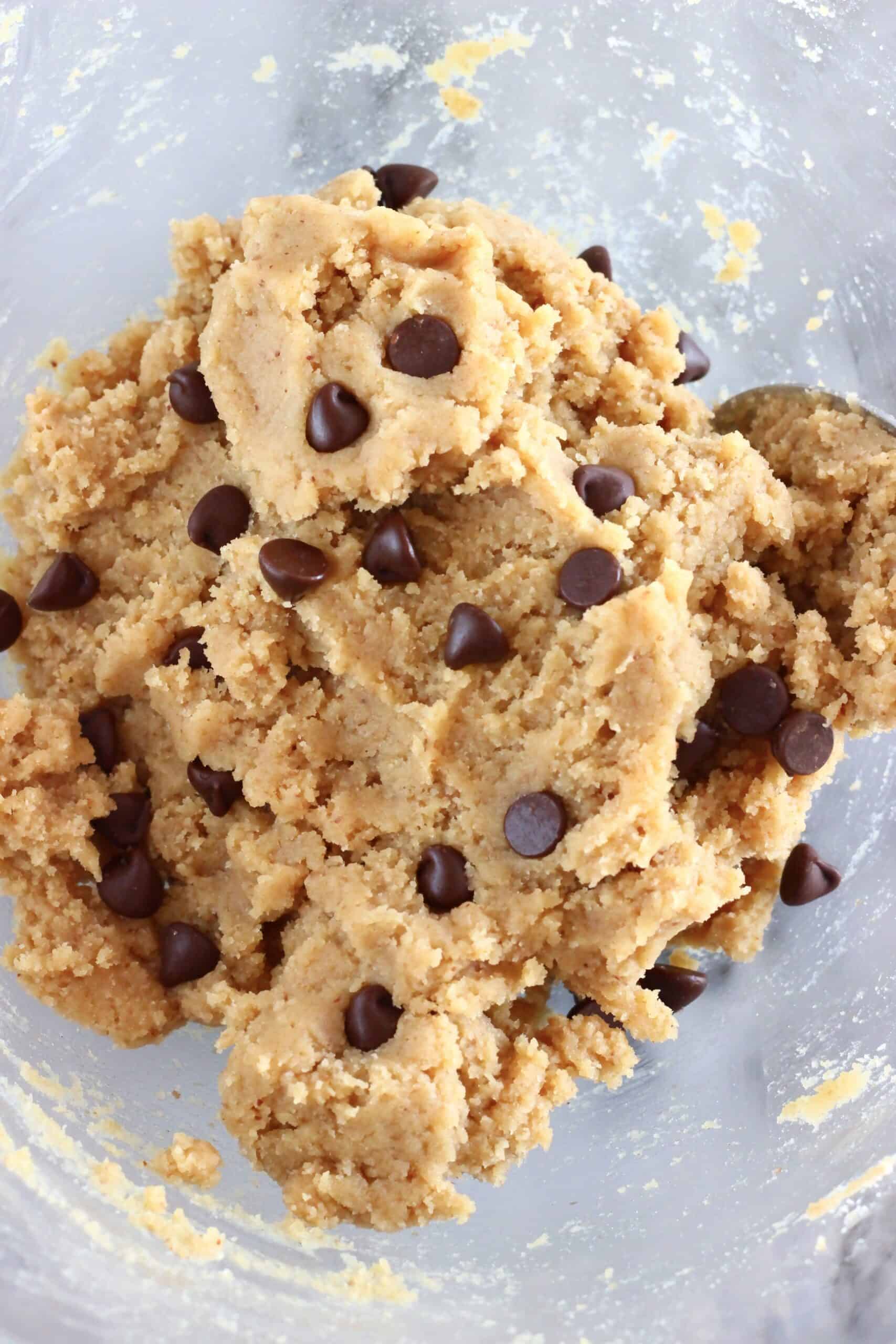 Raw gluten-free vegan chocolate chip cookie bars dough in a mixing bowl