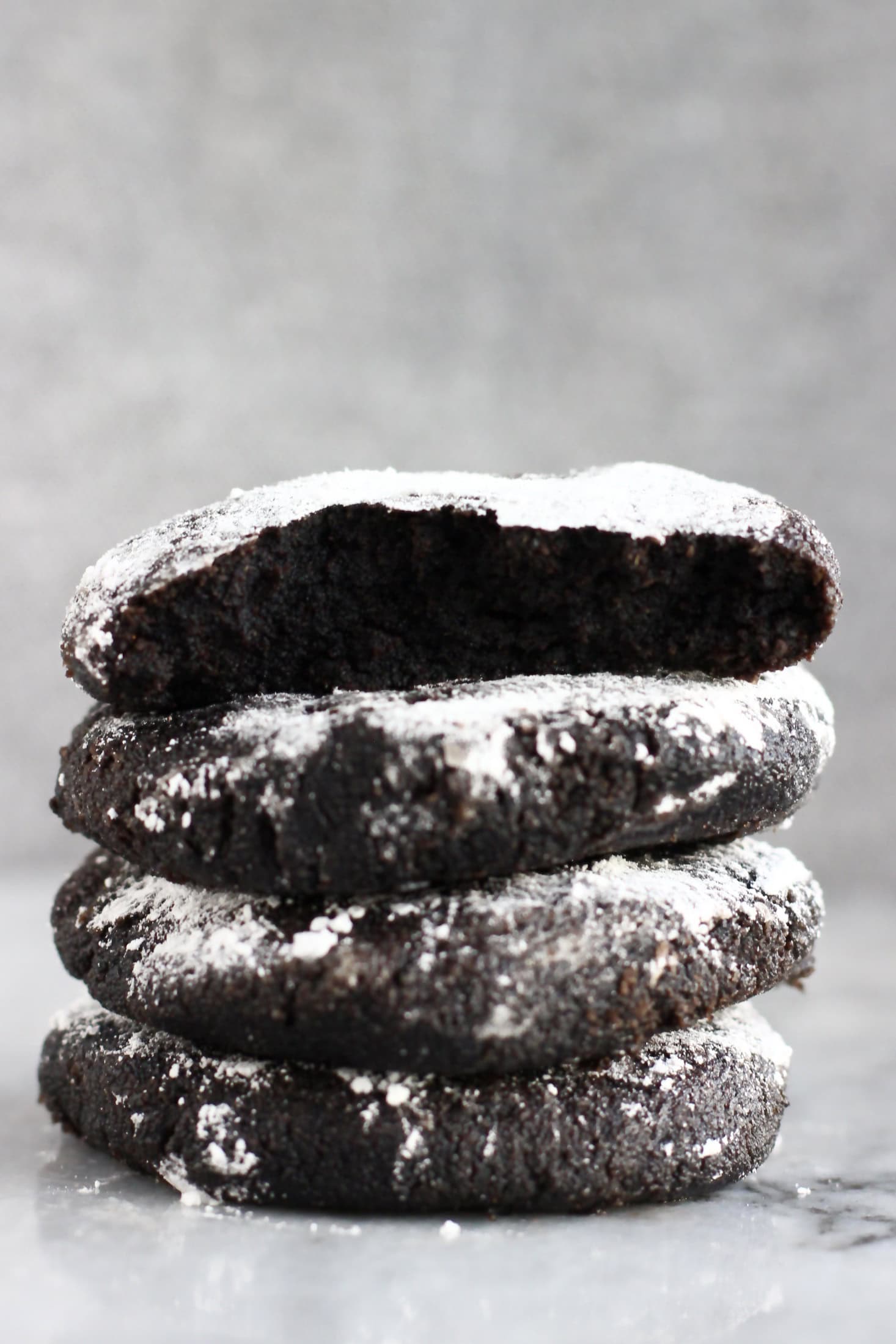 A stack of four gluten-free vegan chocolate crinkle cookies