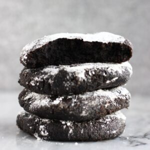 A stack of four gluten-free vegan chocolate crinkle cookies