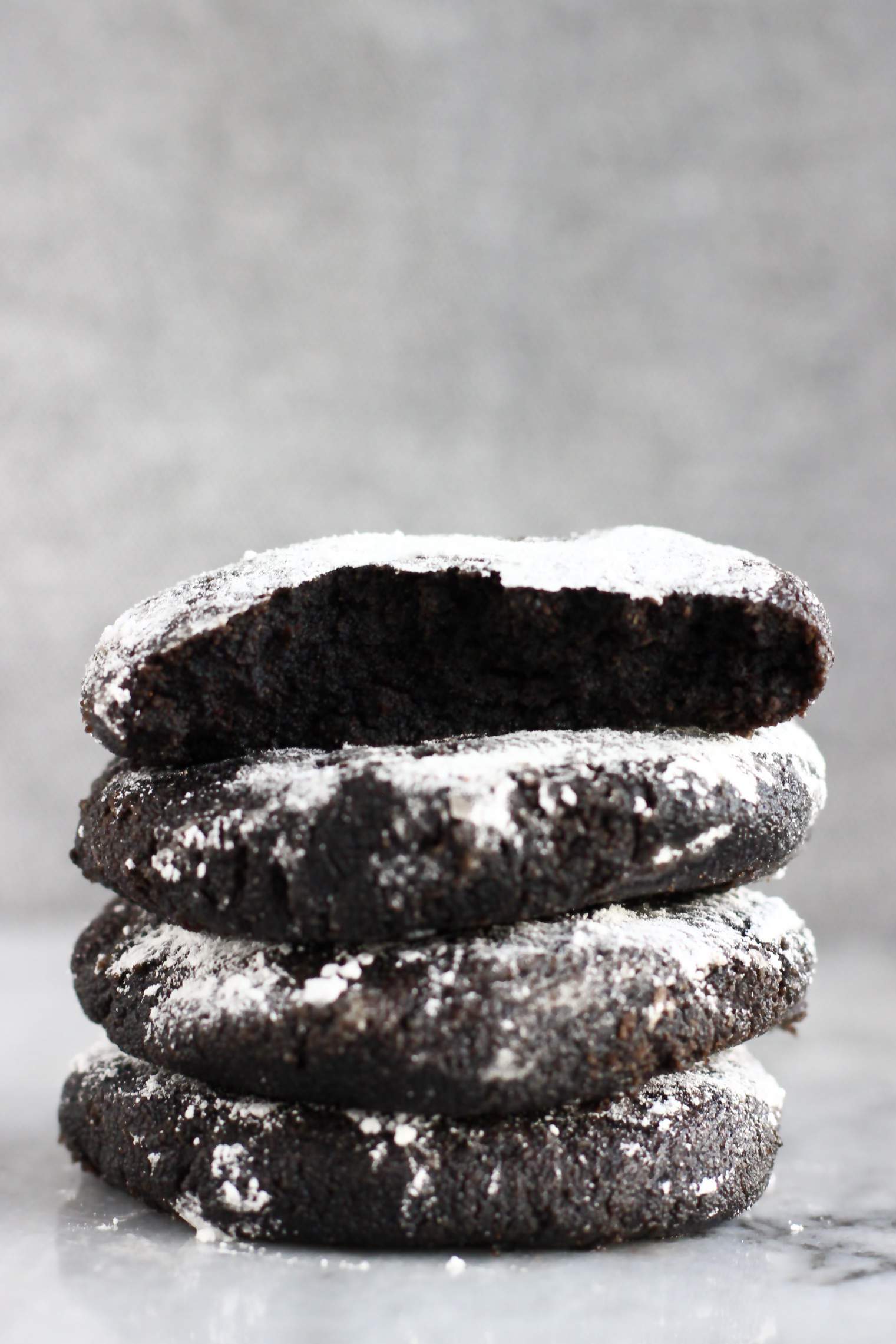 A stack of four gluten-free vegan chocolate crinkle cookies