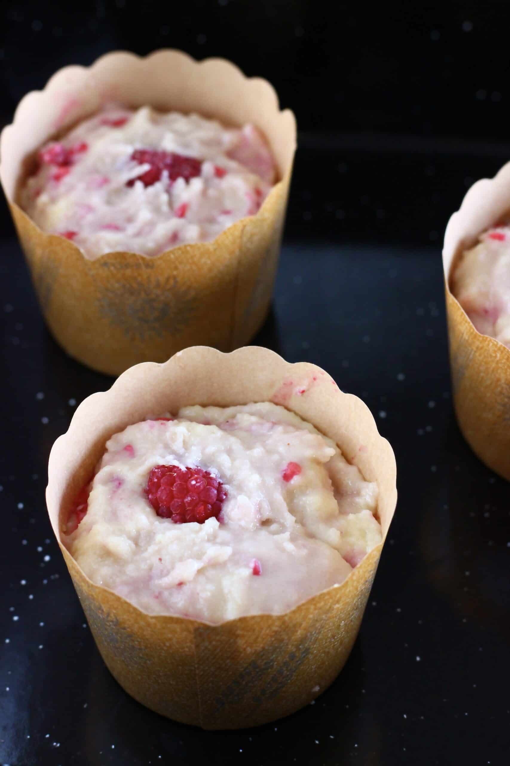 Raw gluten-free vegan raspberry muffins batter in muffin cases