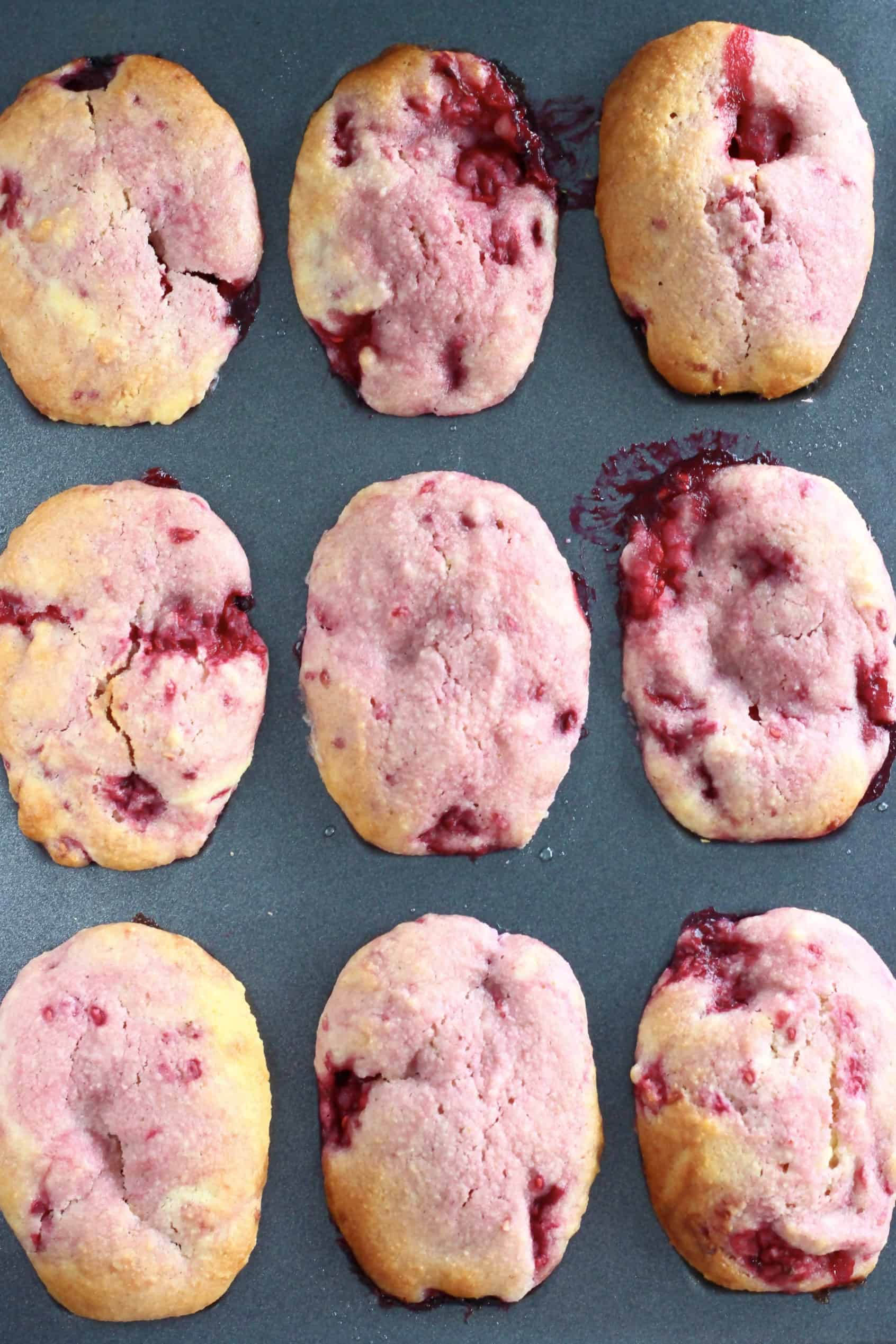 Baked gluten-free vegan raspberry madeleines in a madeleine tin