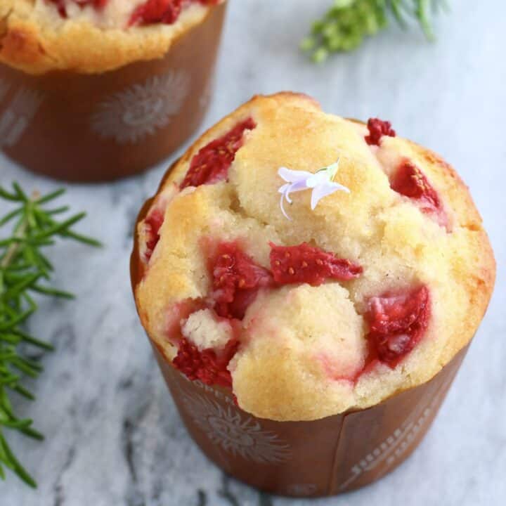 Two gluten-free vegan strawberry muffins on a marble background