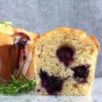 A halved gluten-free vegan lemon blueberry muffin
