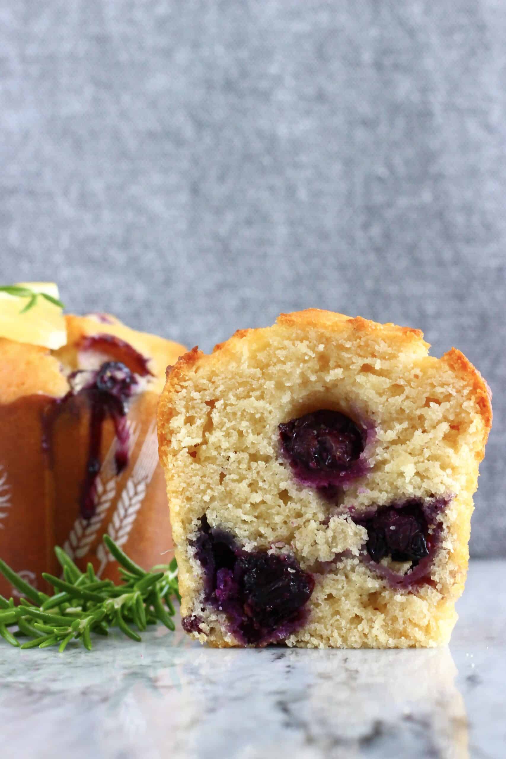 A halved gluten-free vegan lemon blueberry muffin