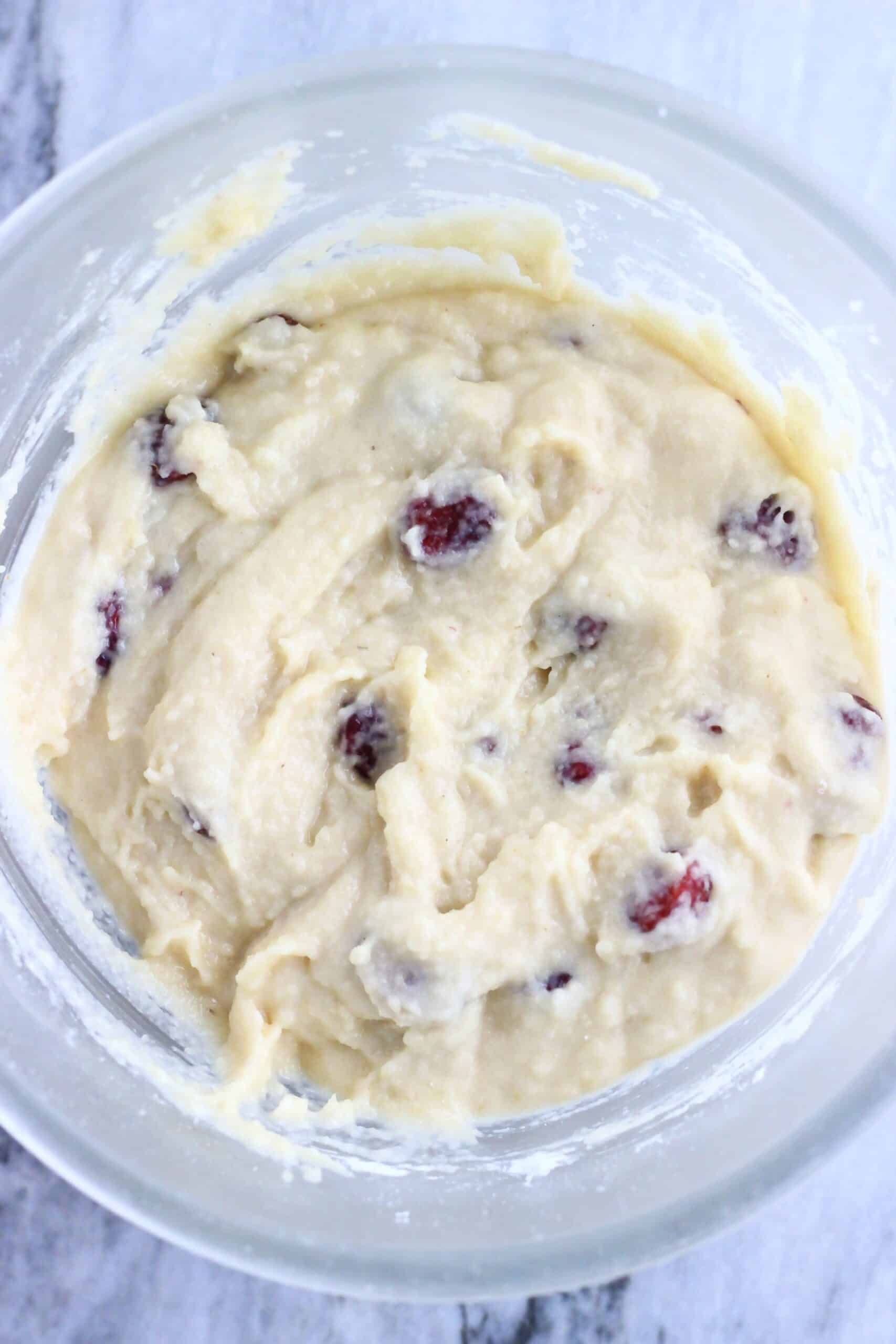 Raw gluten-free vegan cranberry muffins batter in a mixing bowl