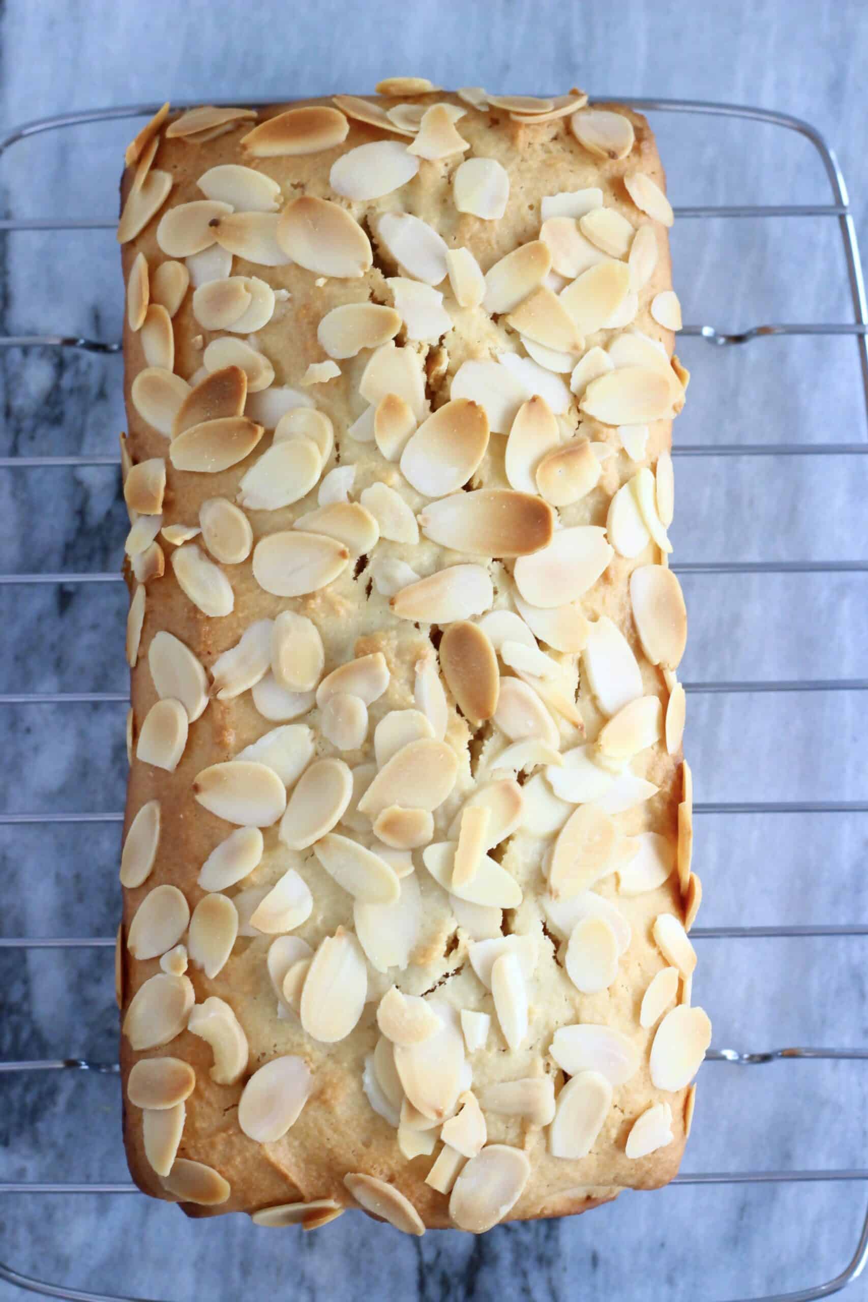 Baked gluten-free vegan almond loaf cake on a wire rack