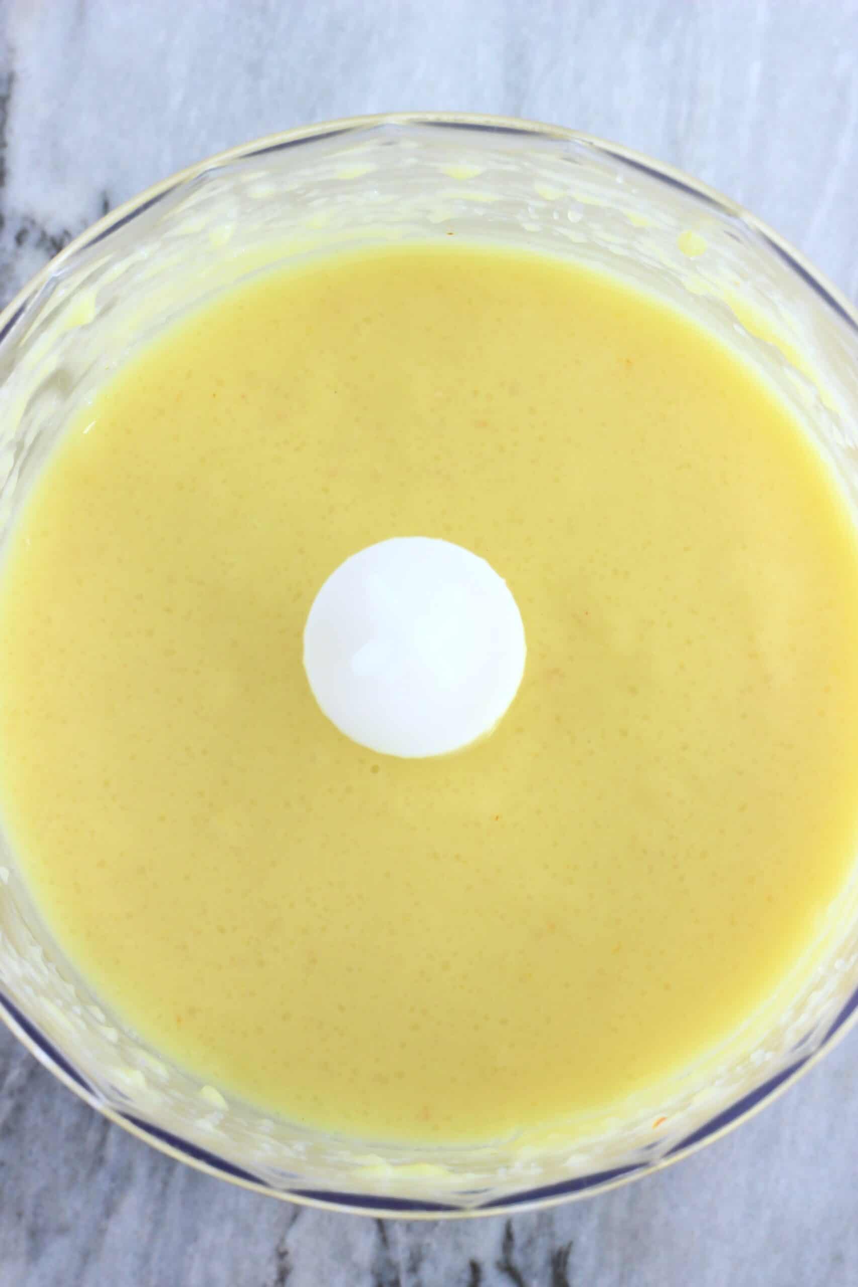 Blended rice, saffron and plant-based milk mixture in a food processor