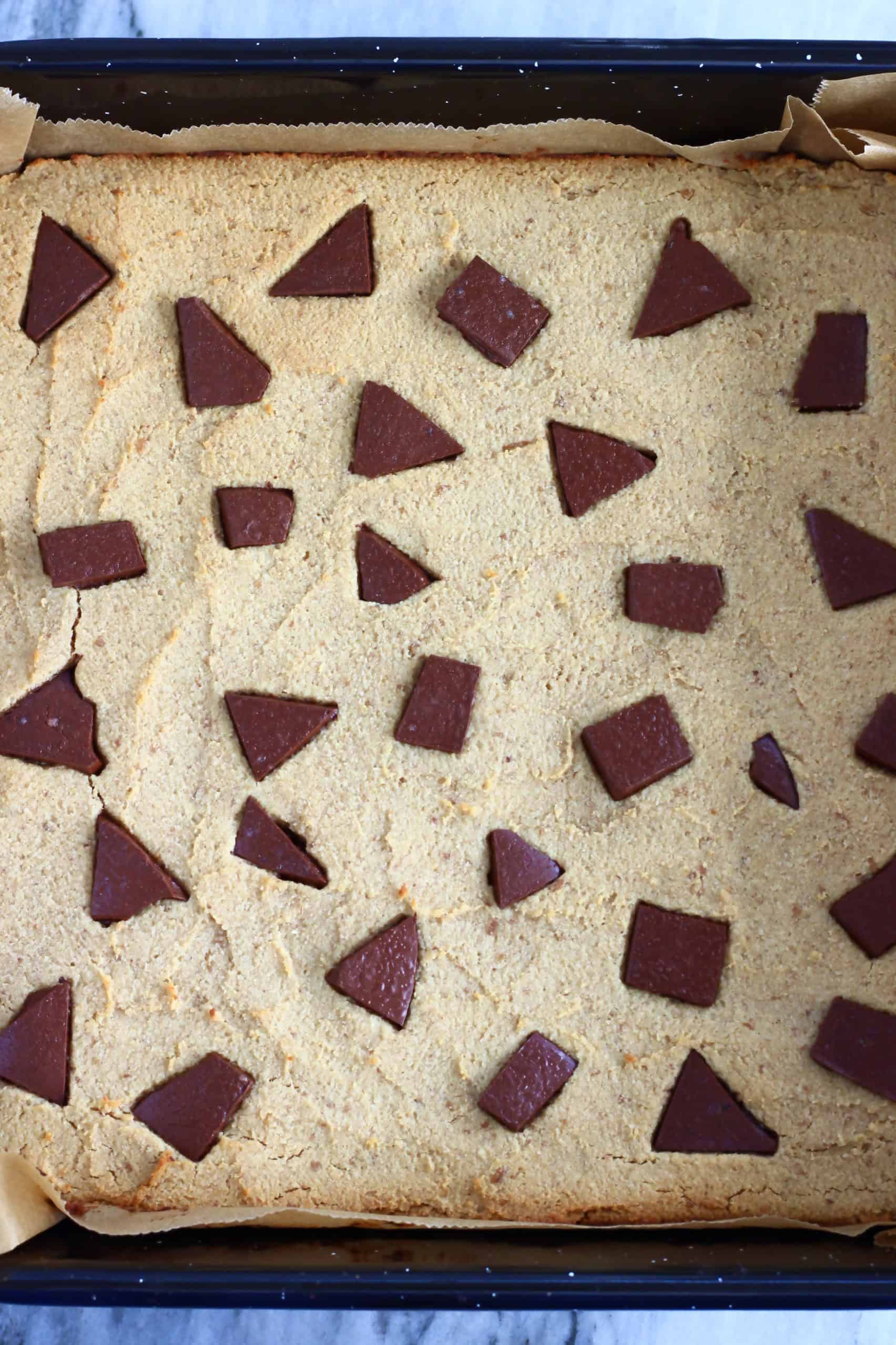 Baked chickpea blondies in a square baking tin lined with baking paper