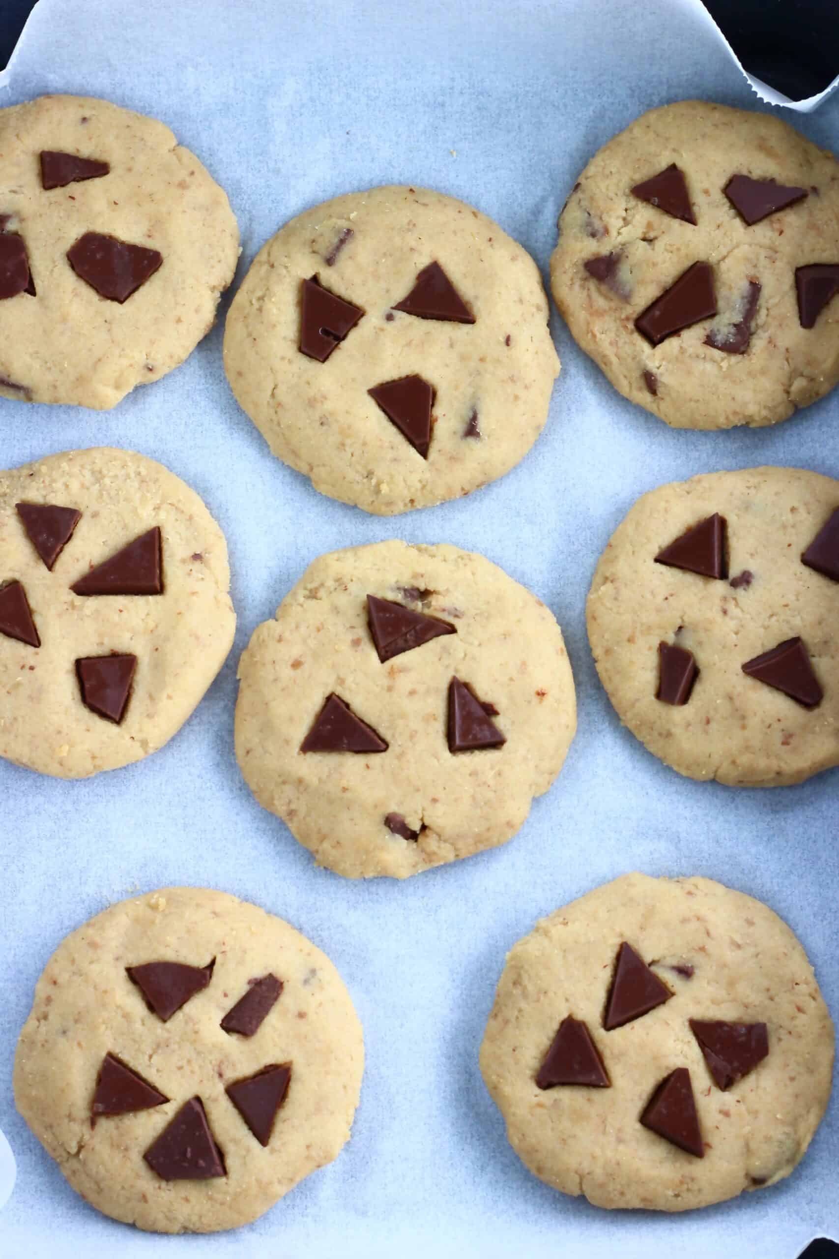 Raw chickpea cookies on a baking tray lined with baking paper