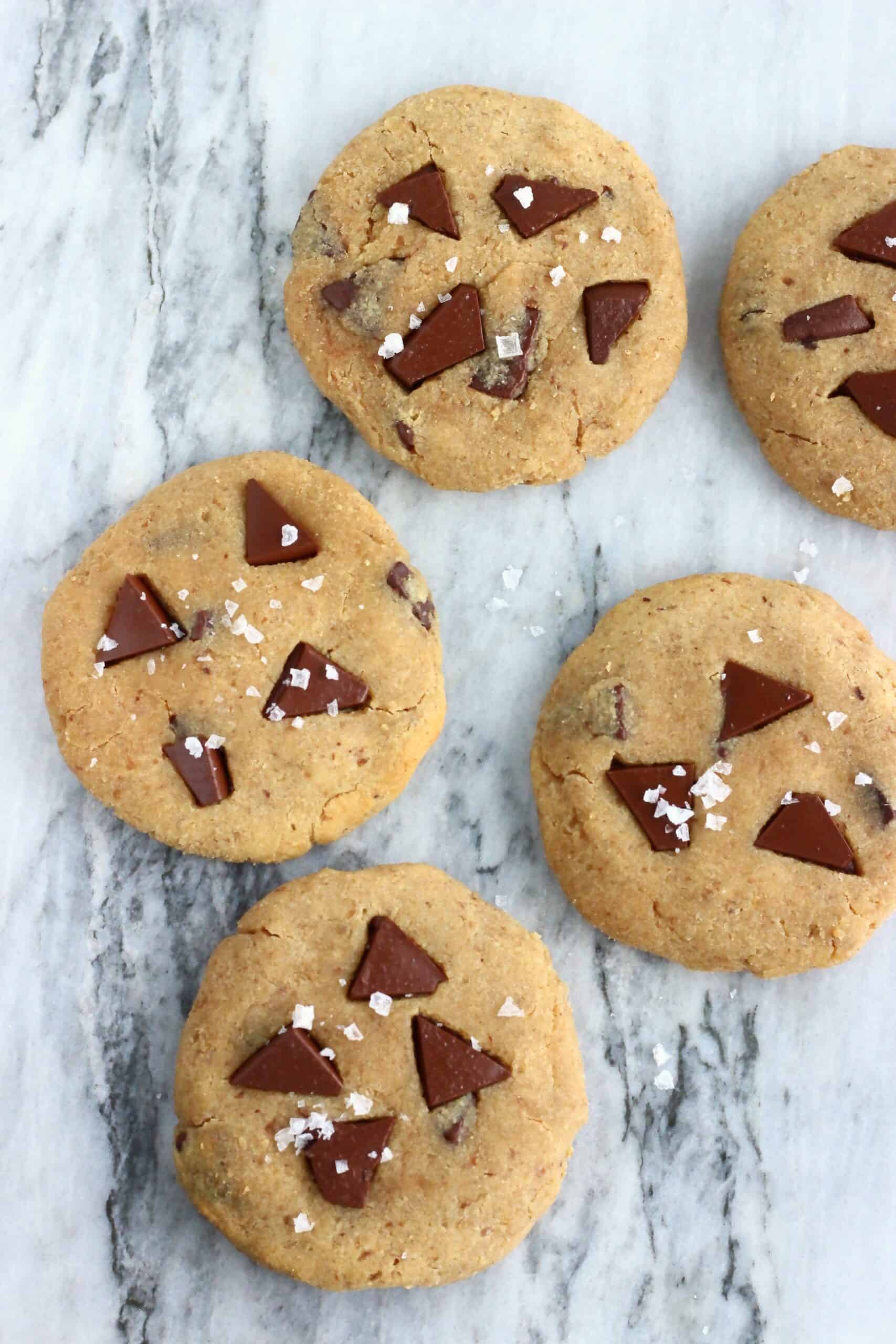 Five chickpea cookies with chocolate chips on a marble background
