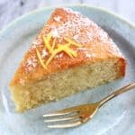 A slice of gluten-free vegan lemon olive oil cake on a plate with a fork