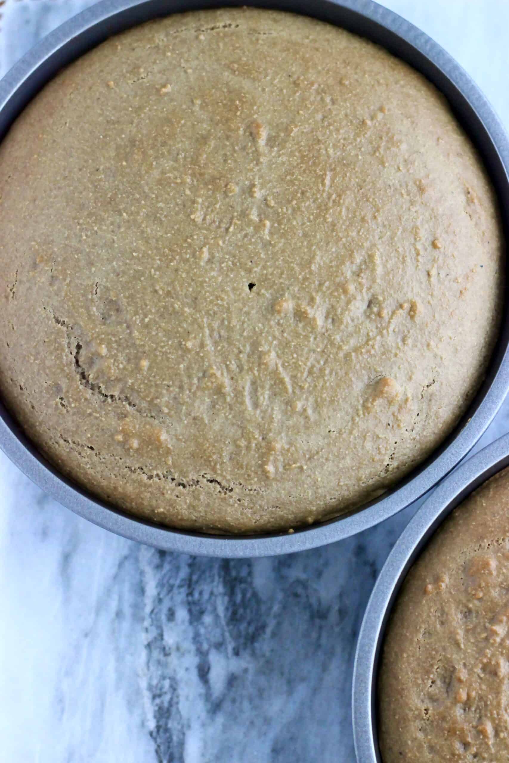 Baked vegan hojicha latte cake sponges in two round baking tins