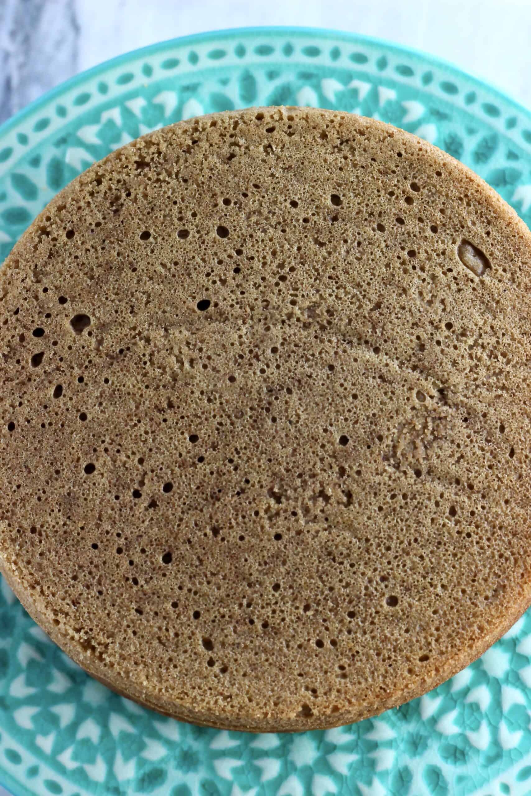 A vegan hojicha latte cake without frosting on a cake stand