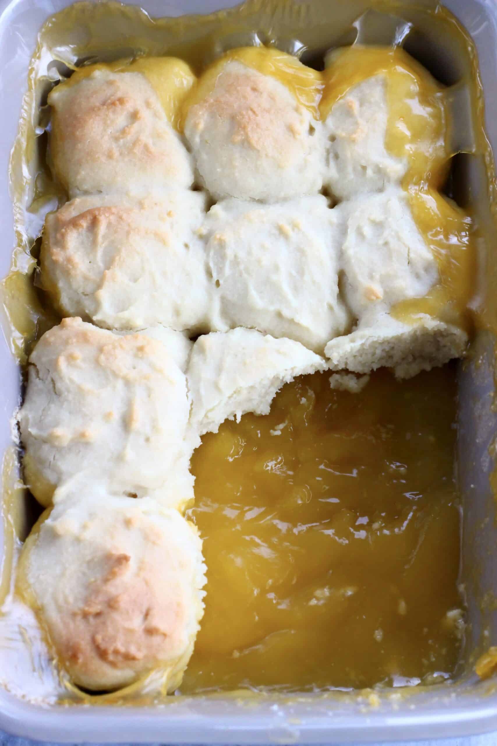 A rectangular baking dish with vegan lemon cobbler