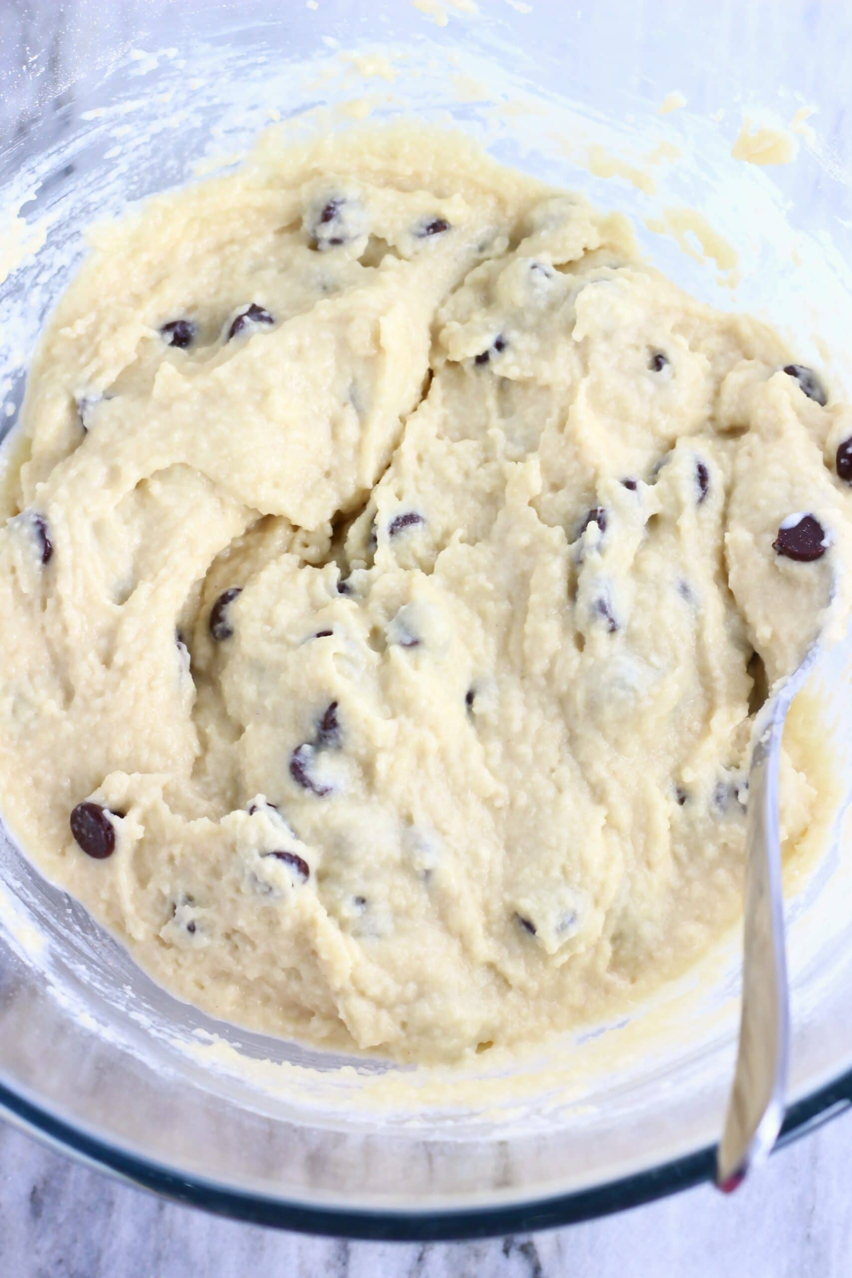 Raw gluten-free vegan chocolate chip scones dough in a mixing bowl