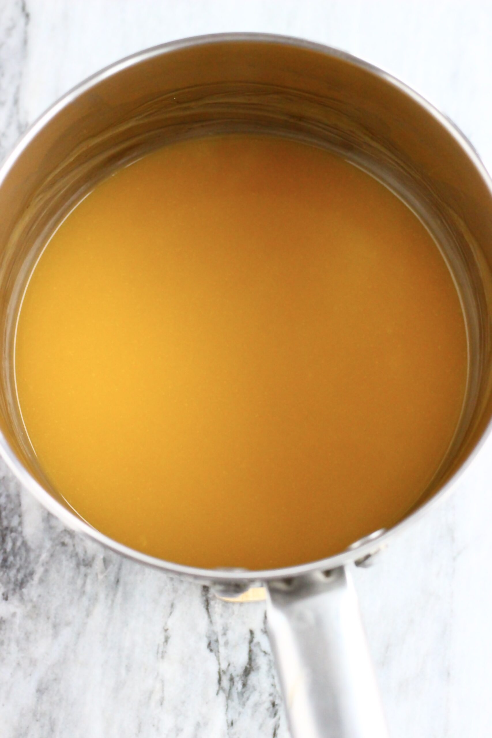 Vegan lemon curd for vegan lemon thumbprint cookies in a saucepan