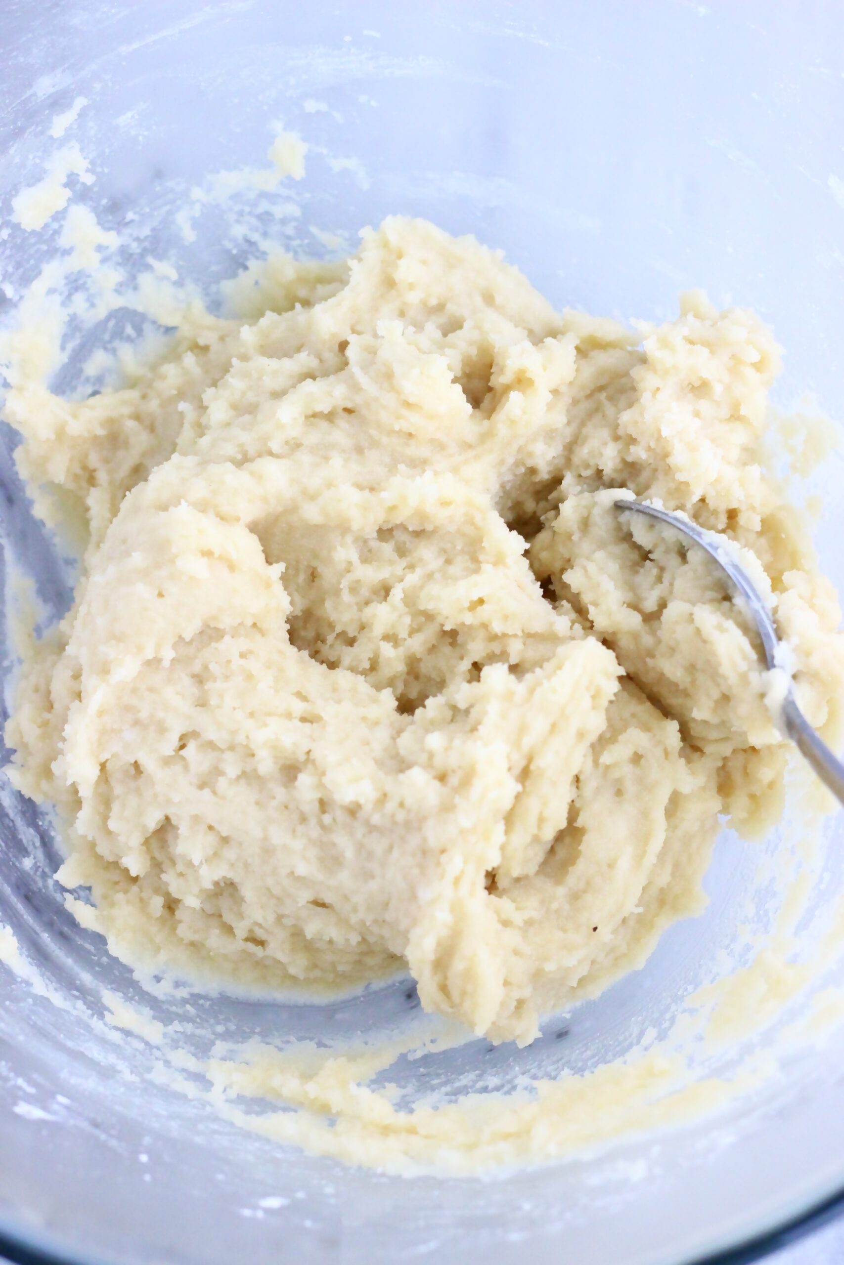 Raw vegan lemon thumbprint cookie dough in a bowl with a spoon