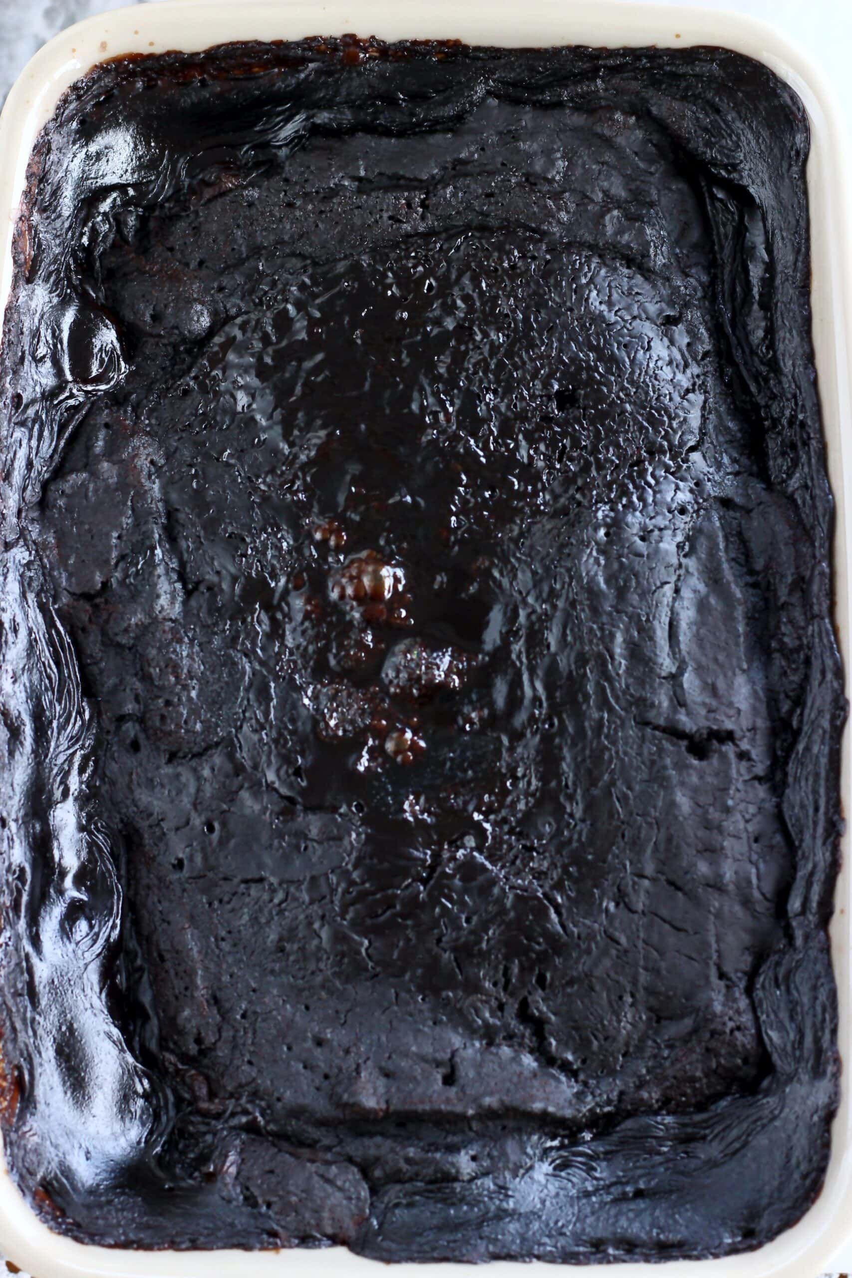 A cooked vegan chocolate self-saucing pudding in a rectangular baking dish