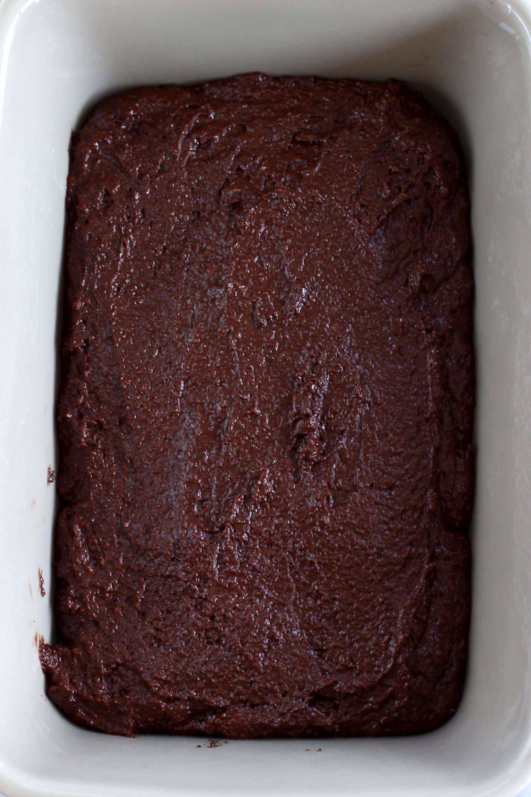 Raw vegan chocolate fudge pudding batter in a rectangular baking dish