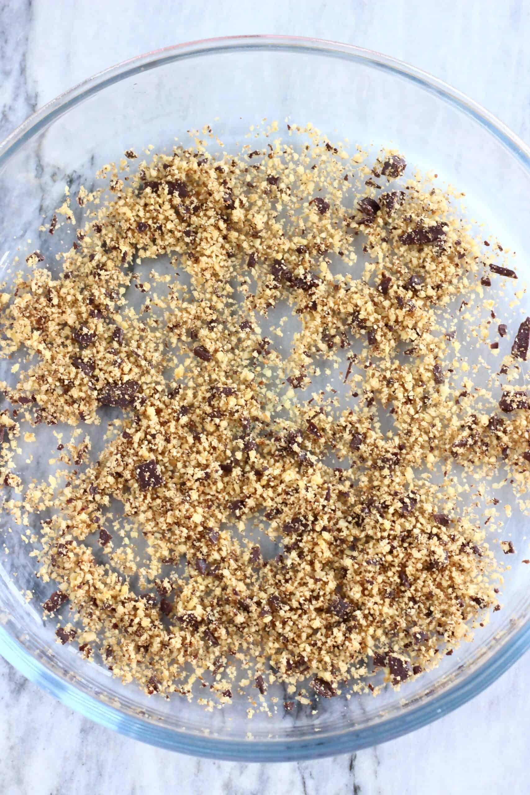 Blended nuts and chocolate mixture scattered across a round glass baking dish