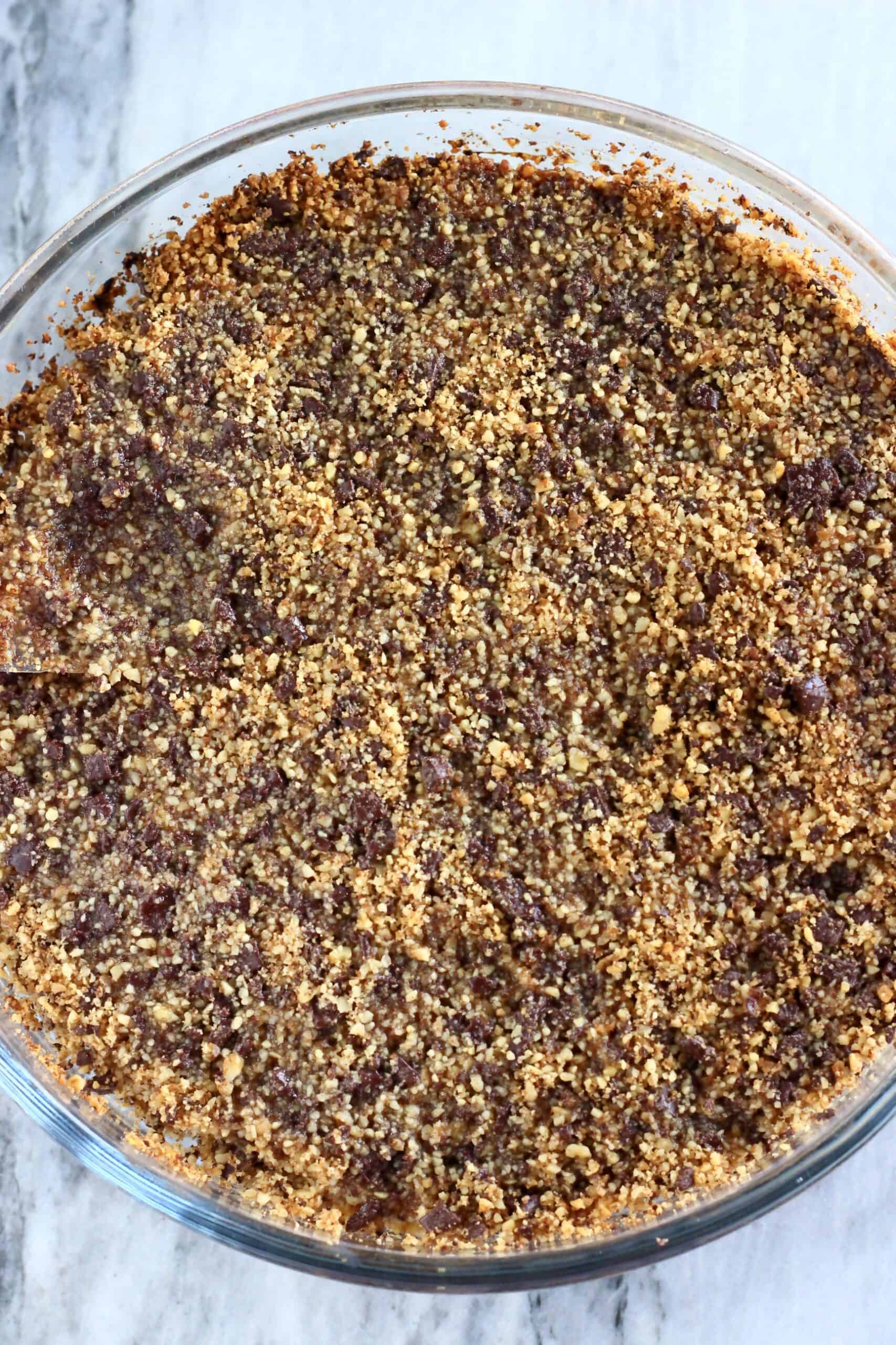 Gluten-free vegan chocolate baklava soaked in syrup in a round baking dish