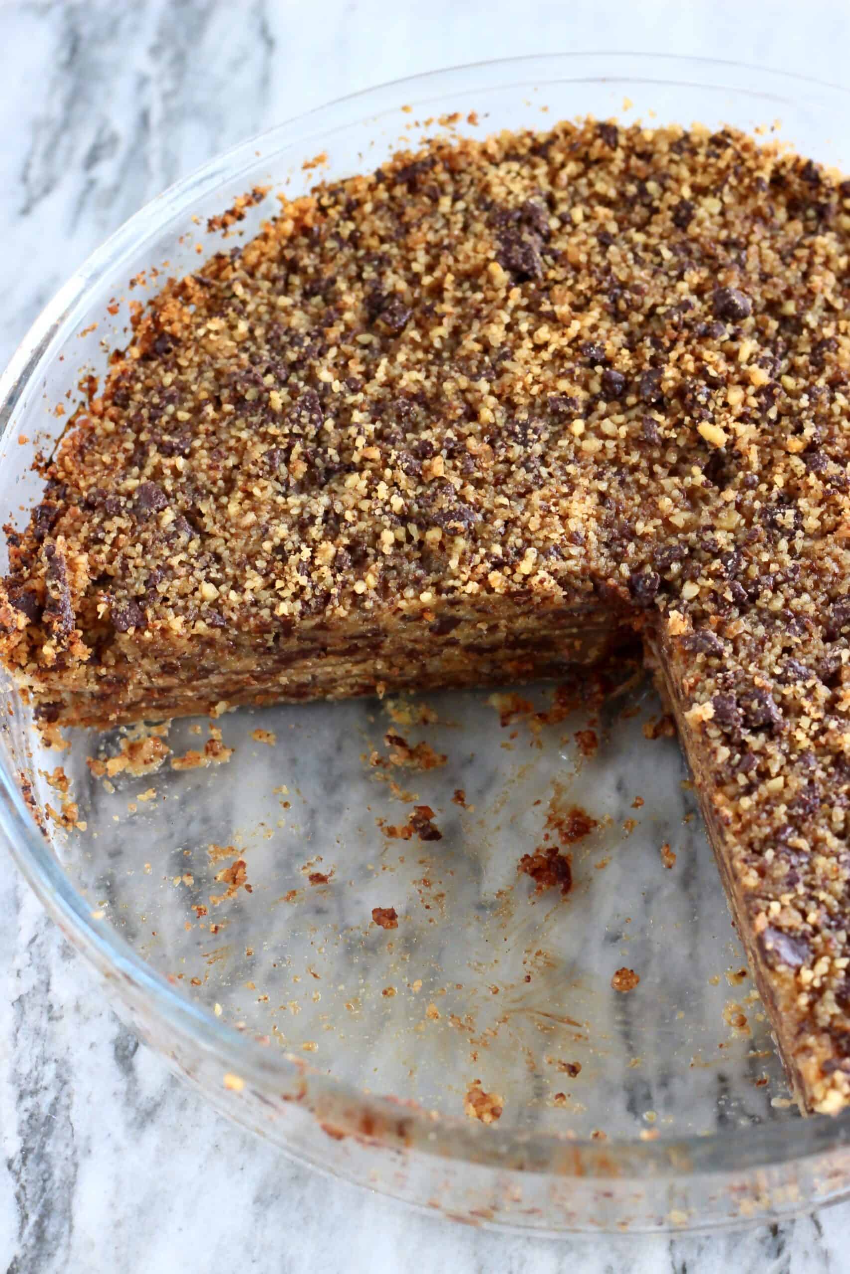 Gluten-free vegan chocolate baklava in a round baking dish with a slice taken out of it