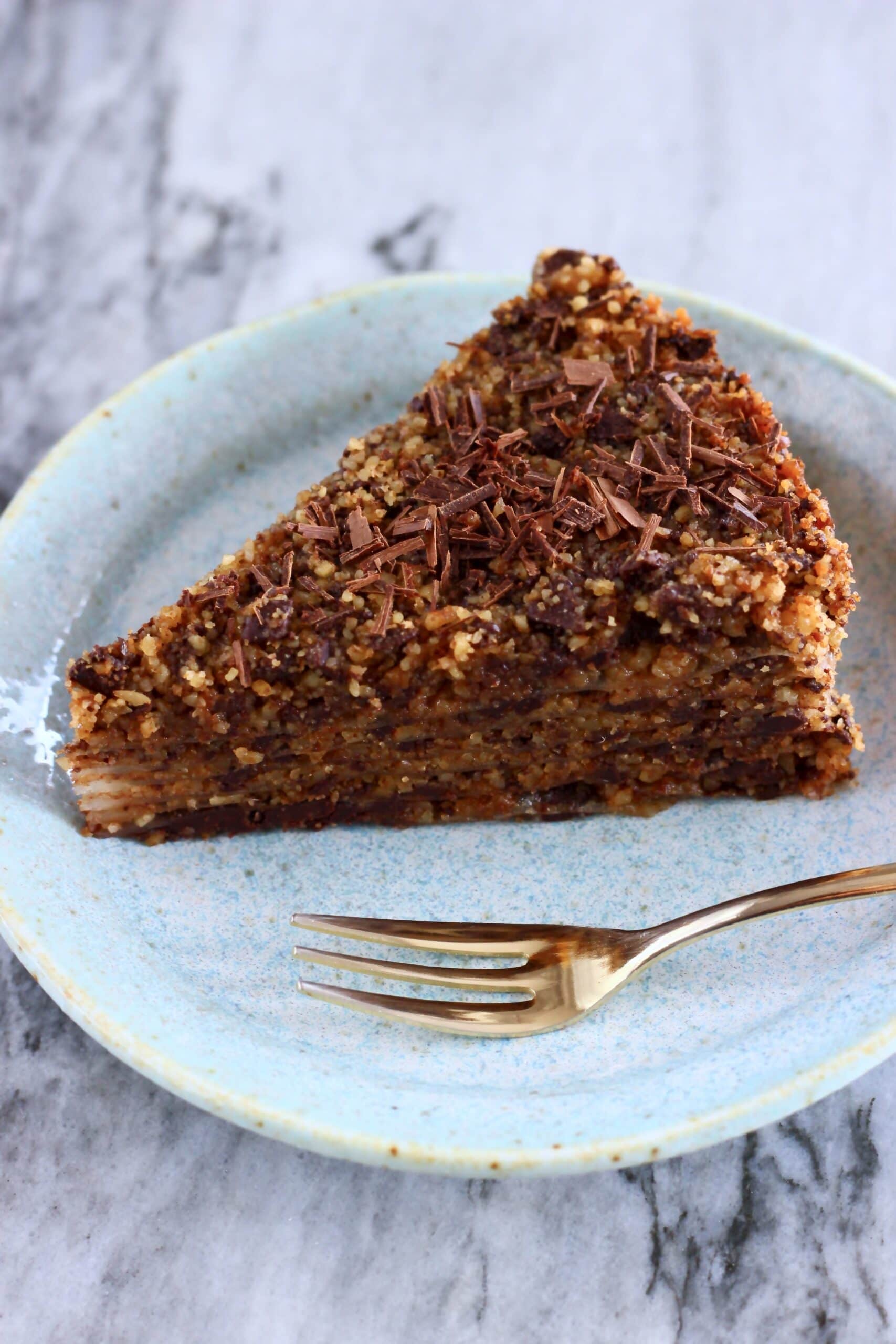 A slice of gluten-free vegan chocolate baklava on a plate with a fork