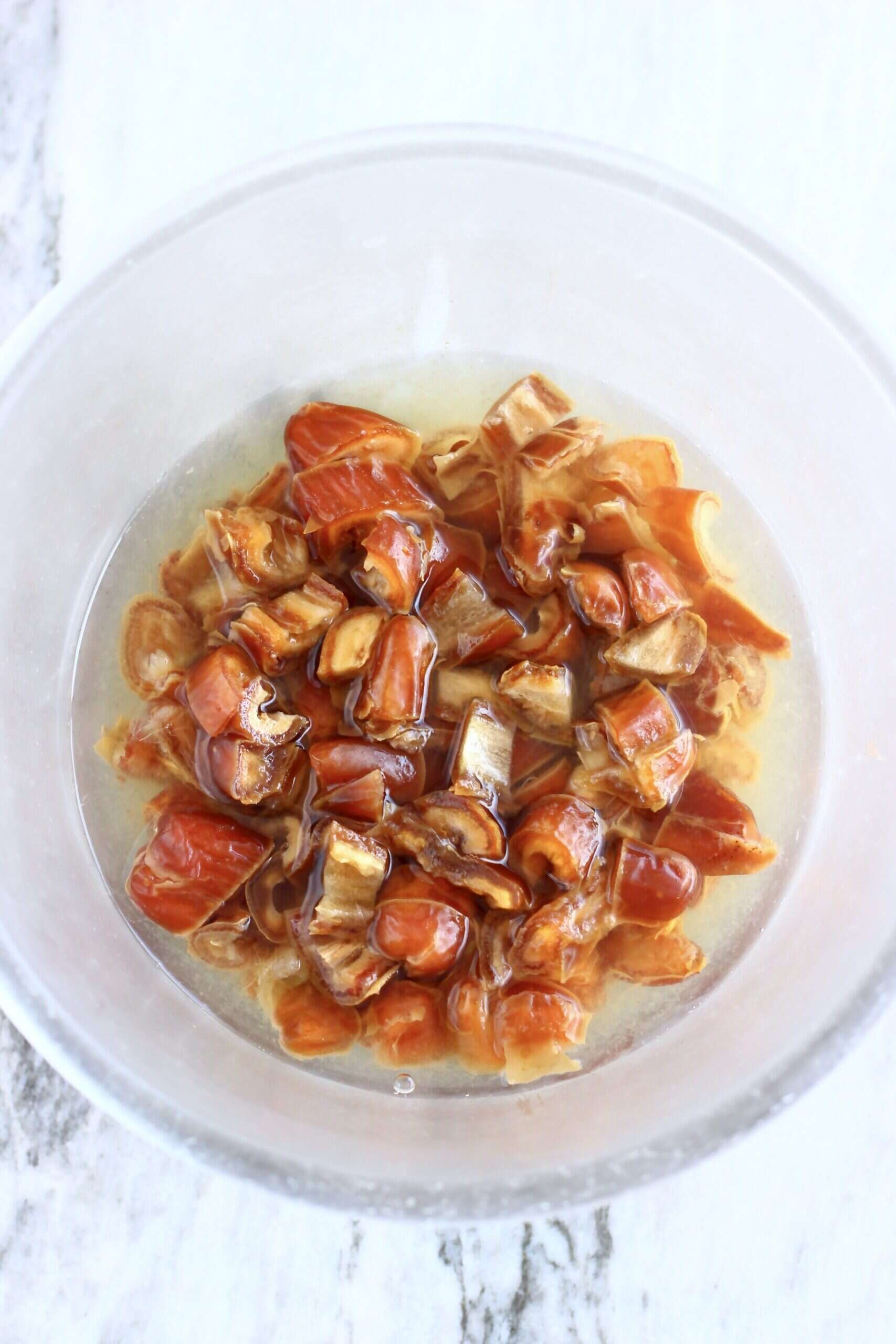 Chopped dates in a bowl with hot water