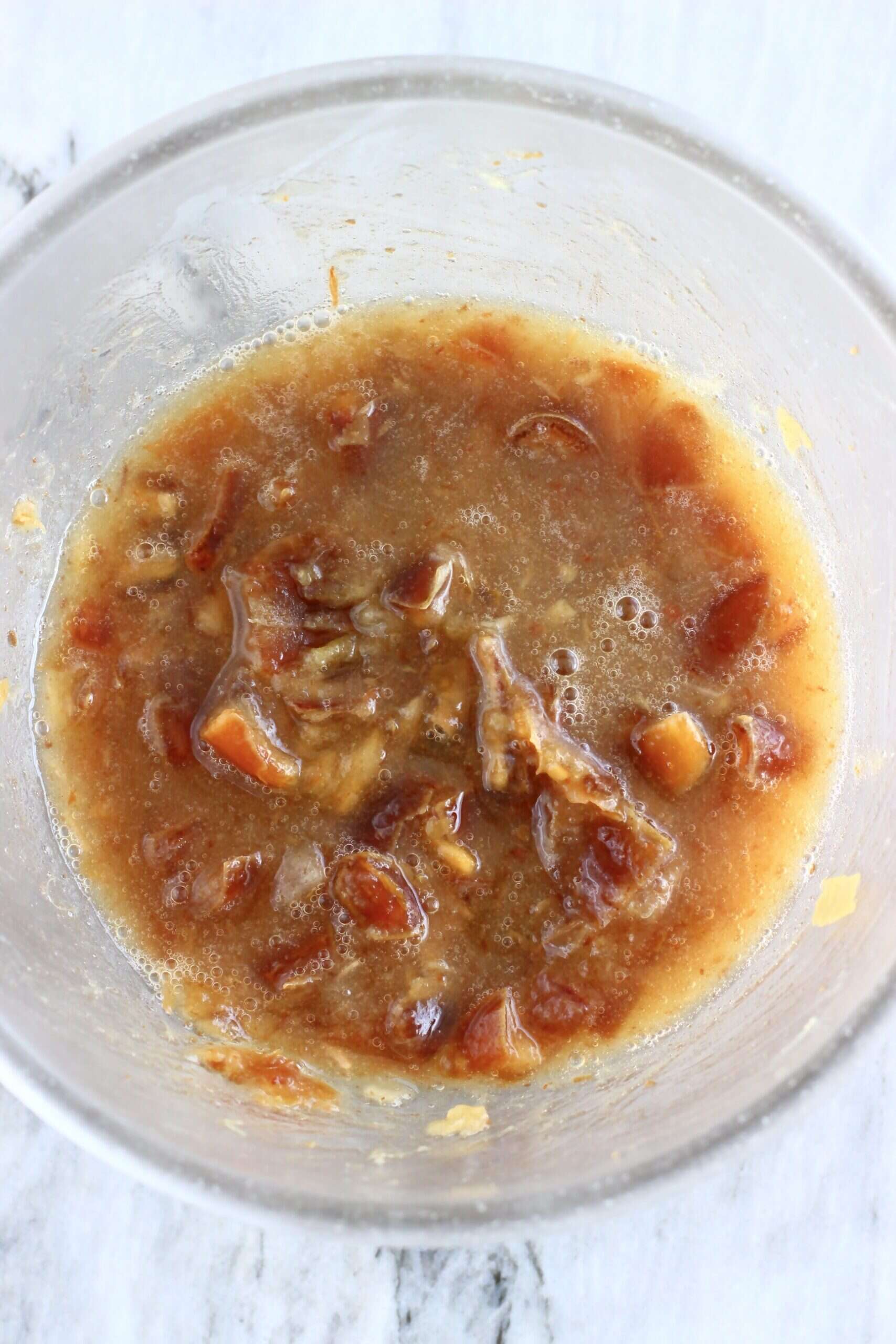 Mashed soaked dates with hot water in a bowl