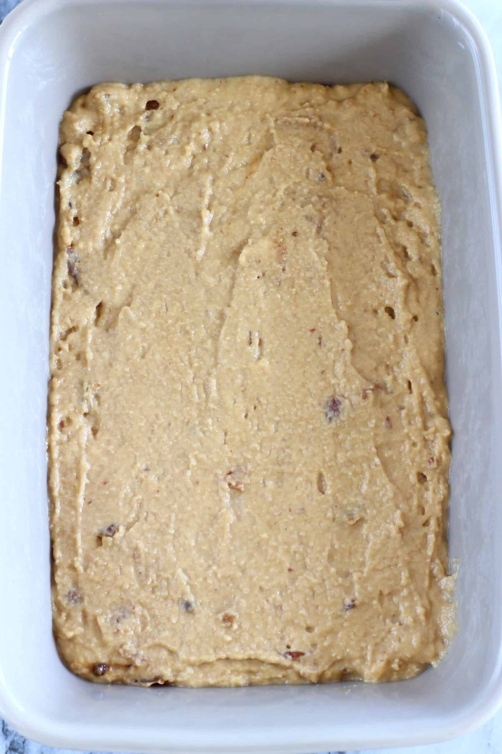 Raw vegan sticky toffee pudding batter in a rectangular baking dish