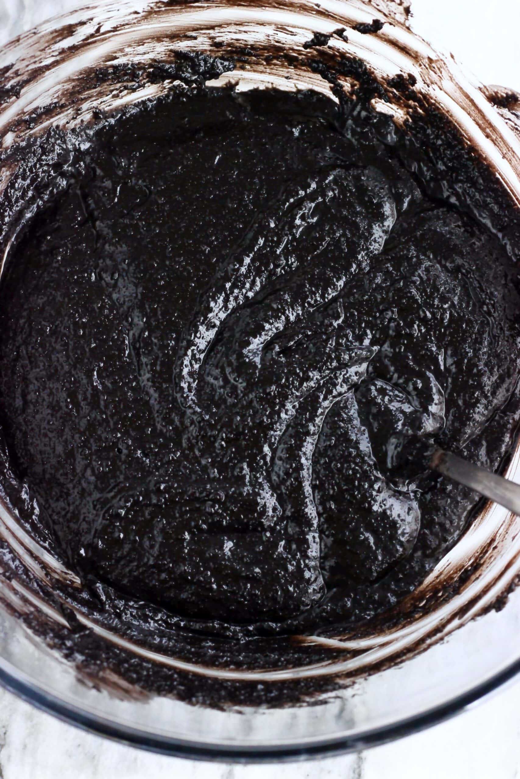 Raw vegan chocolate Christmas pudding batter in a bowl with a spoon