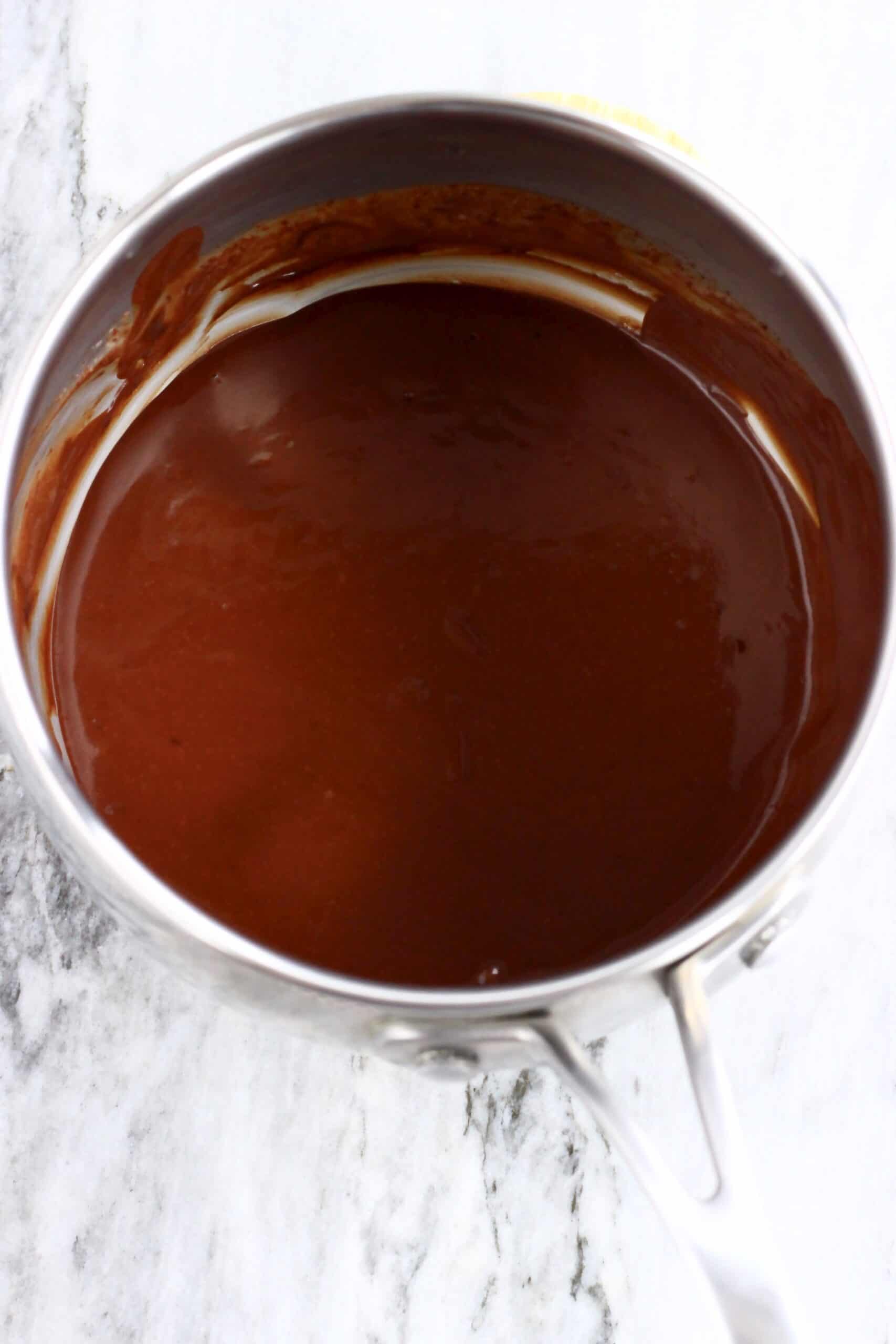 Vegan chocolate sauce for vegan chocolate Christmas pudding in a saucepan