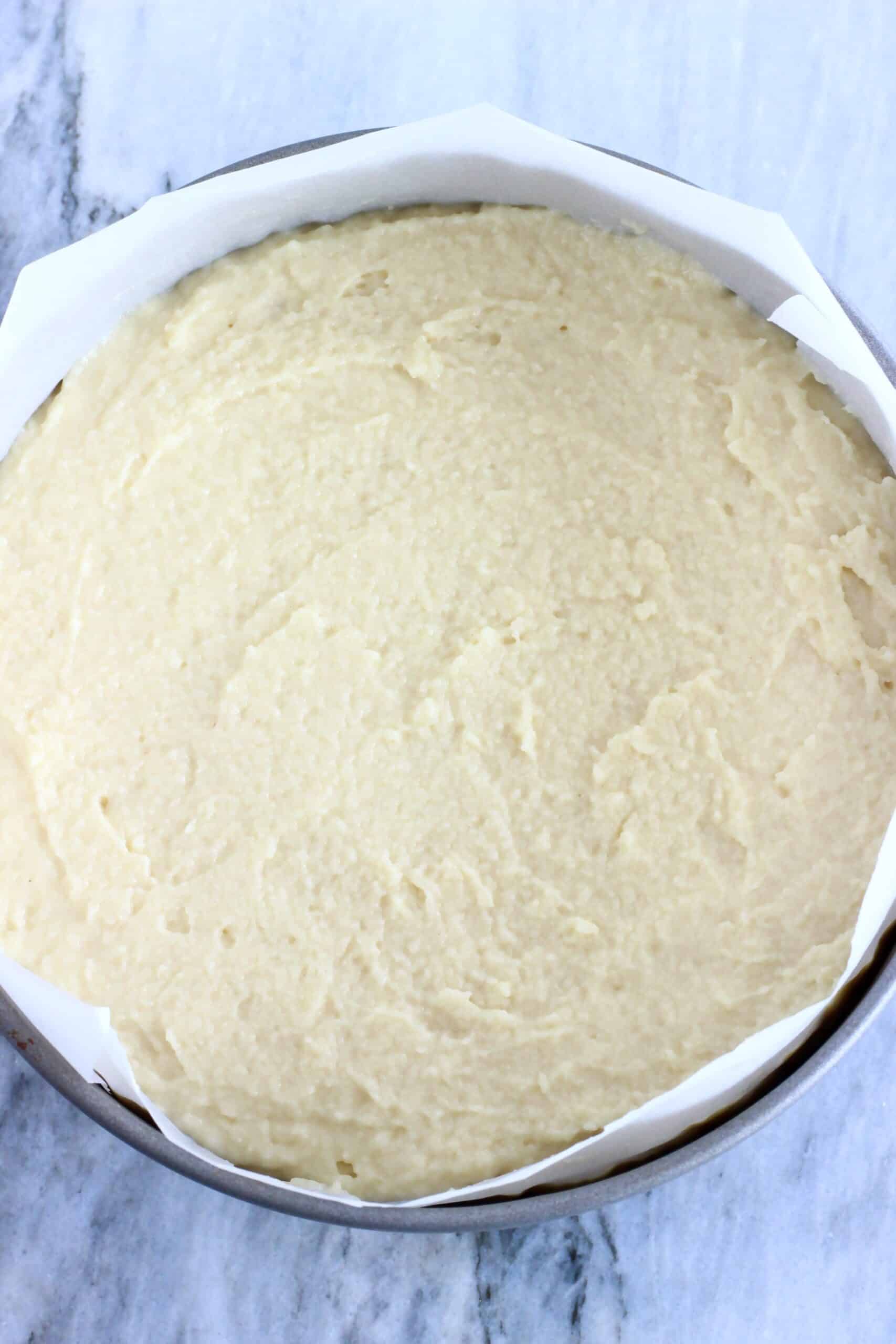 Vegan Honey Cake batter in a round springform baking tin lined with baking paper