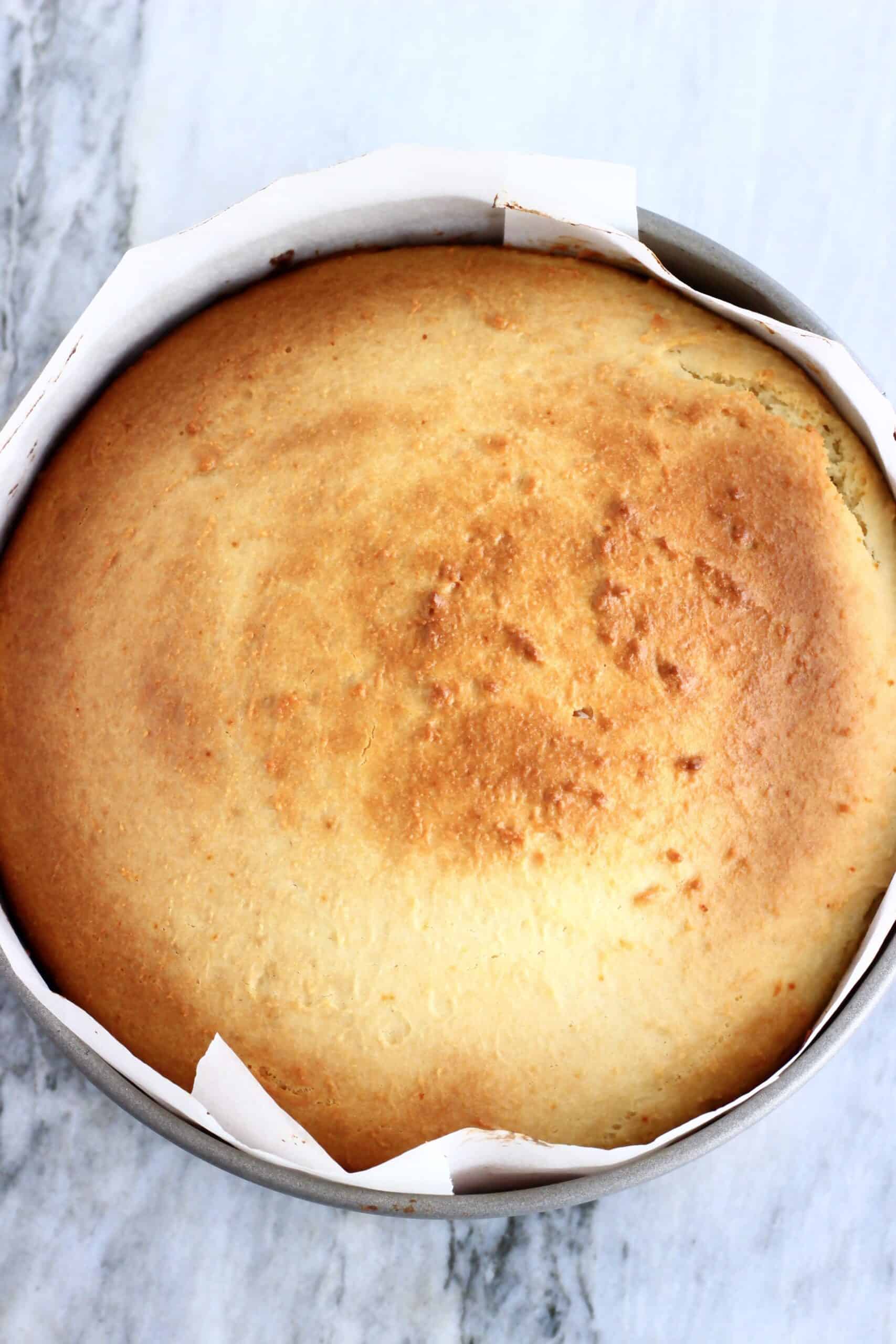 A baked Vegan Honey Cake in a round springform baking tin lined with baking paper