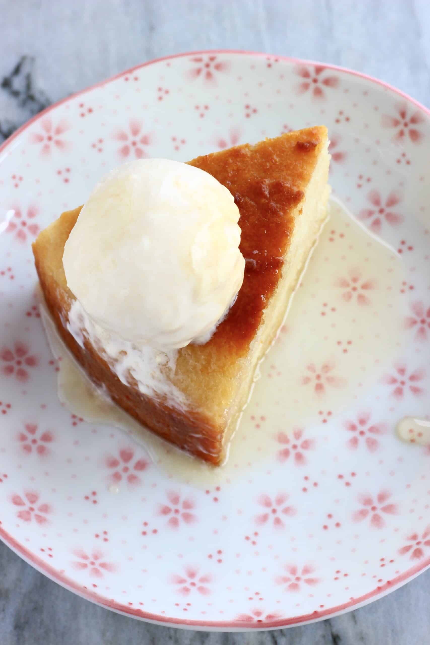 A slice of Vegan Honey Cake on a plate with a scoop of vanilla ice cream