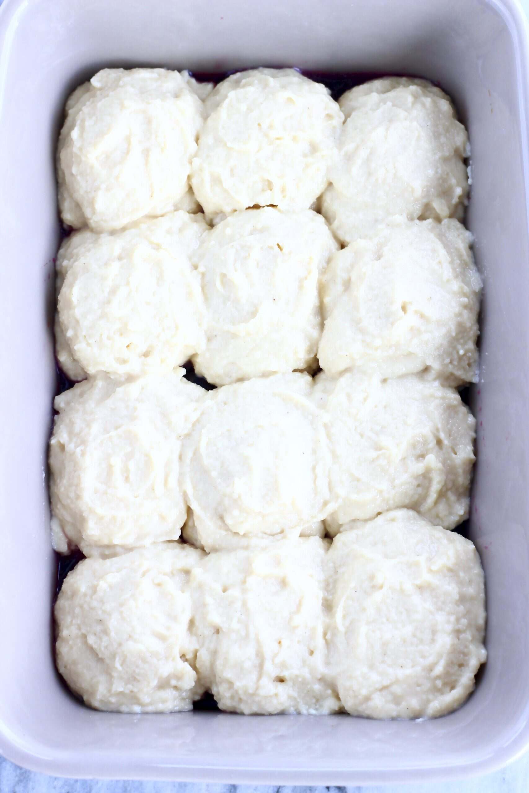 Raw Vegan Blueberry Cobbler topped with dough in a rectangular baking dish